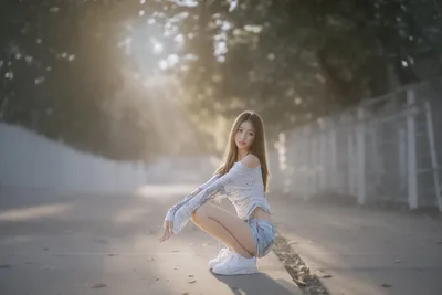 Woman Crouching in Sunlit Urban Alley - free people & portraits wallpaper 6144×4098