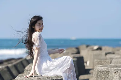 Woman in White Dress Sitting on Coastal Rocks - free people & portraits wallpaper 5120×3418