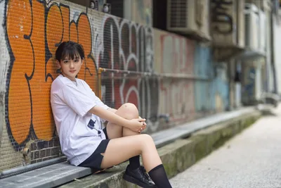 Young Woman Posing Against Urban Graffiti Wall - free wallpaper 5120×3418