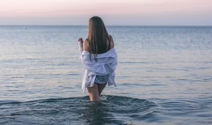 Woman in White Shirt Wading in Calm Ocean at Dusk - free people & portraits wallpaper 5390×3177