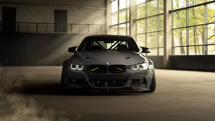 Black Sports Car in Sunlit Warehouse - free cars & vehicles wallpaper 7680×4320