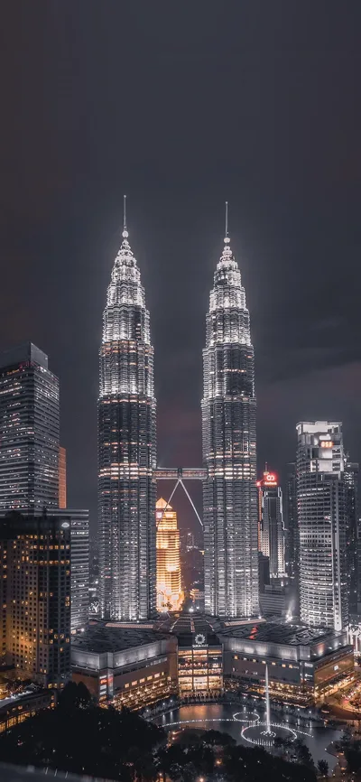 Twin Towers Illuminated Night Cityscape - free cars & vehicles wallpaper 1125×2436