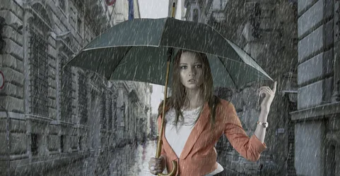 Woman With Umbrella In Heavy Rain On Urban Street - free wallpaper 9449×4912