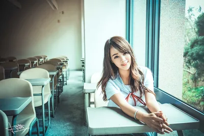 Young Woman in Classroom by Sunny Window - free wallpaper 5760×3840