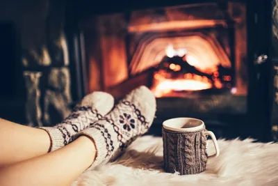 Cozy Fireplace Scene with Warm Beverages and Wool Socks - free photography wallpaper 4240×2832