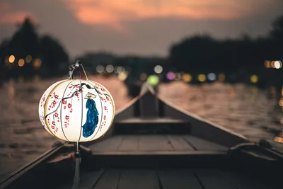 Illuminated Asian Lantern on Wooden Boat Deck at Dusk - free photography wallpaper 6000×4000