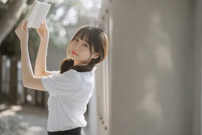 Young Woman Reading Document by White Wall - free wallpaper 6144×4096