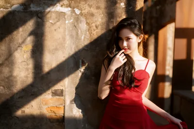 Woman in Red Dress Against Weathered Stone Wall - free wallpaper 6144×4098