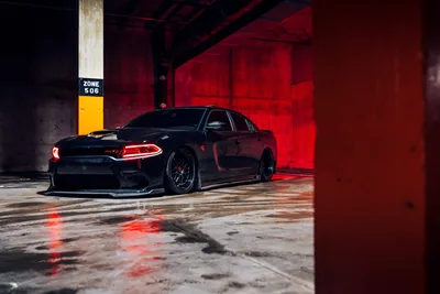 Black Sports Sedan in Red-Lit Industrial Parking Garage - free cars & vehicles wallpaper 5770×3847