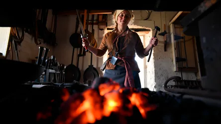 Blacksmith Woman at Forge with Tools and Fire - free wallpaper 3840×2160