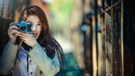 Woman Holding Blue Olympus Camera in Alley - free people & portraits wallpaper 5760×3240