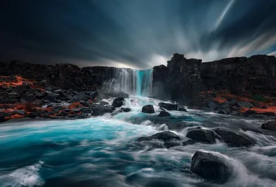 Turquoise Waterfall Cascading Through Dark Rocky Landscape - free wallpaper 2048×1386