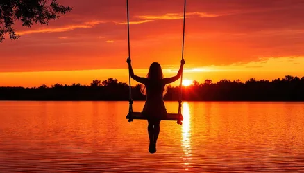 Woman on Swing at Sunset Over Water - free wallpaper 2688×1536