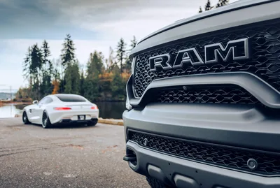 RAM Truck Front Grille with Sports Car by Lake - free wallpaper 6274×4218
