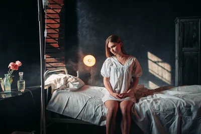 Woman Sitting on Bed in Dramatic Studio Lighting - free wallpaper 1920×1282