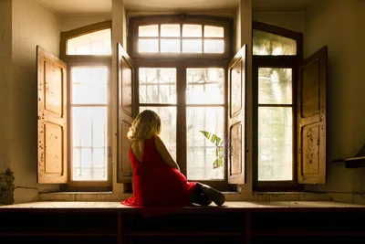 Woman in Red Dress Sitting by Open Windows - free wallpaper 5793×3862