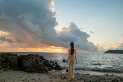 Woman in Cream Dress Watching Sunset Over Rocky Beach - free wallpaper 6000×4000
