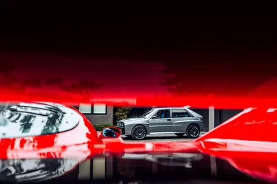 Silver BMW M3 Among Red Sports Cars in Modern Garage - free cars & vehicles wallpaper 6720×4480