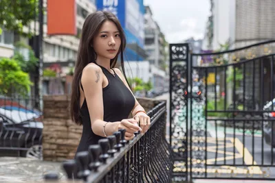 Woman in Black Top on Urban Street Balcony - free wallpaper 5120×3413