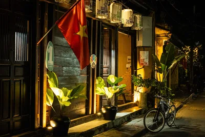 Vietnamese Shop Front at Night with Flag and Plants - free city & urban wallpaper 2048×1365