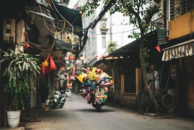 Colorful Toy-Laden Scooter in Historic Vietnamese Alley - free wallpaper 2048×1365