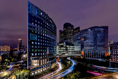 Urban Nightscape With Illuminated Skyscrapers and Light Trails - free city & urban wallpaper 2879×1920