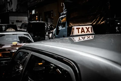 Illuminated Taxi Sign on Urban Street at Night - free cars & vehicles wallpaper 4670×3120
