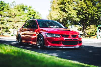 Red Mitsubishi Lancer Evolution Parked on Sunny Street - free cars & vehicles wallpaper 6000×4000