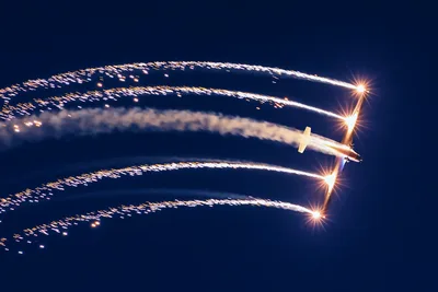 Military Aircraft Deploying Flares Against Night Sky - free wallpaper 5472×3648