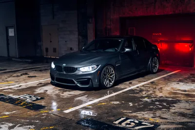 Dark BMW M3 Sedan in Industrial Parking Garage - free wallpaper 5951×3967