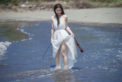 Woman in White Dress Wading in Ocean Waves - free wallpaper 5120×3413