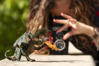 Girl Photographing Fantasy Dragon Figurine Outdoors - free photography wallpaper 6000×4000