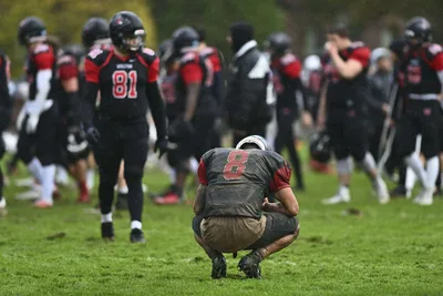 Young Football Player in Crouched Position During Rain - free people & portraits wallpaper 5120×3413