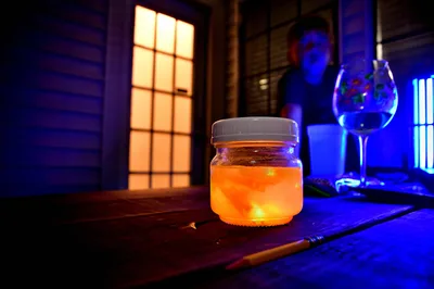 Glowing Orange Jar in Neon-Lit Laboratory Studio - free wallpaper 6000×3996