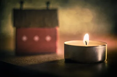 Lit Tea Light Candle With Blurred Red Candle Behind - free photography wallpaper 6048×4024