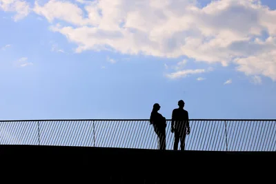 Two Silhouetted Figures Standing on Modern Bridge - free people & portraits wallpaper 4096×2731