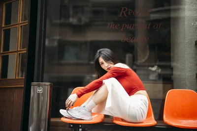 Woman in Red and White Sitting on Orange Chair - free wallpaper 4000×2667
