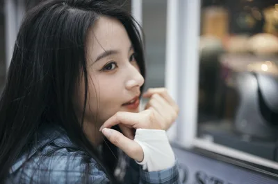 Young Woman Looking Out Window in Contemplative Pose - free wallpaper 4000×2658