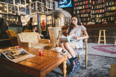 Woman Reading in Modern Bookstore Café - free wallpaper 1920×1280