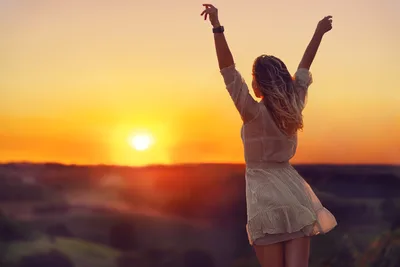Woman Celebrating at Sunset with Arms Raised - free wallpaper 6143×4100