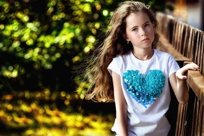 Young Girl in Turquoise Heart Shirt by Garden Fence - free people & portraits wallpaper 2048×1365