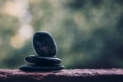 Stacked Black Stones Against Blurred Green Background - free photography wallpaper 1600×1065
