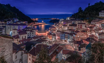Coastal Town Harbor at Twilight with Illuminated Waterfront - free wallpaper 6144×3720