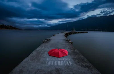 Red Umbrella on Pier at Twilight by Mountains - free photography wallpaper 6144×4007