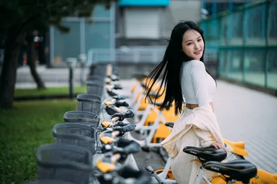 Woman Posing With Yellow Bike-Sharing Fleet - free people & portraits wallpaper 3000×1994