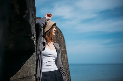 Woman in Hat Gazing at Ocean From Stone Wall - free people & portraits wallpaper 3000×1992