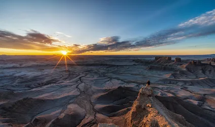 Hiker Atop Desert Rock at Sunset - free landscapes wallpaper 6143×3620