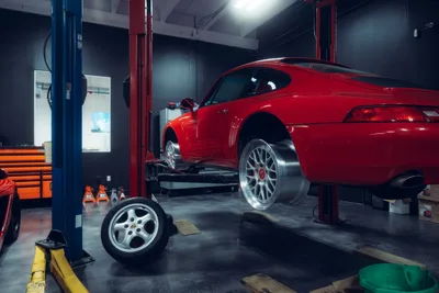 Red Sports Car Lifted In Professional Auto Repair Shop - free cars & vehicles wallpaper 2048×1365