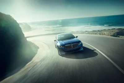 Luxury BMW Sedan Driving Along Coastal Cliff Road - free wallpaper 7952×5304