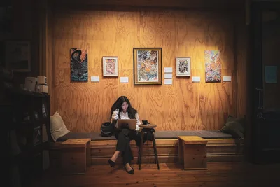 Woman Working on Laptop in Wooden Art Gallery - free people & portraits wallpaper 2048×1365